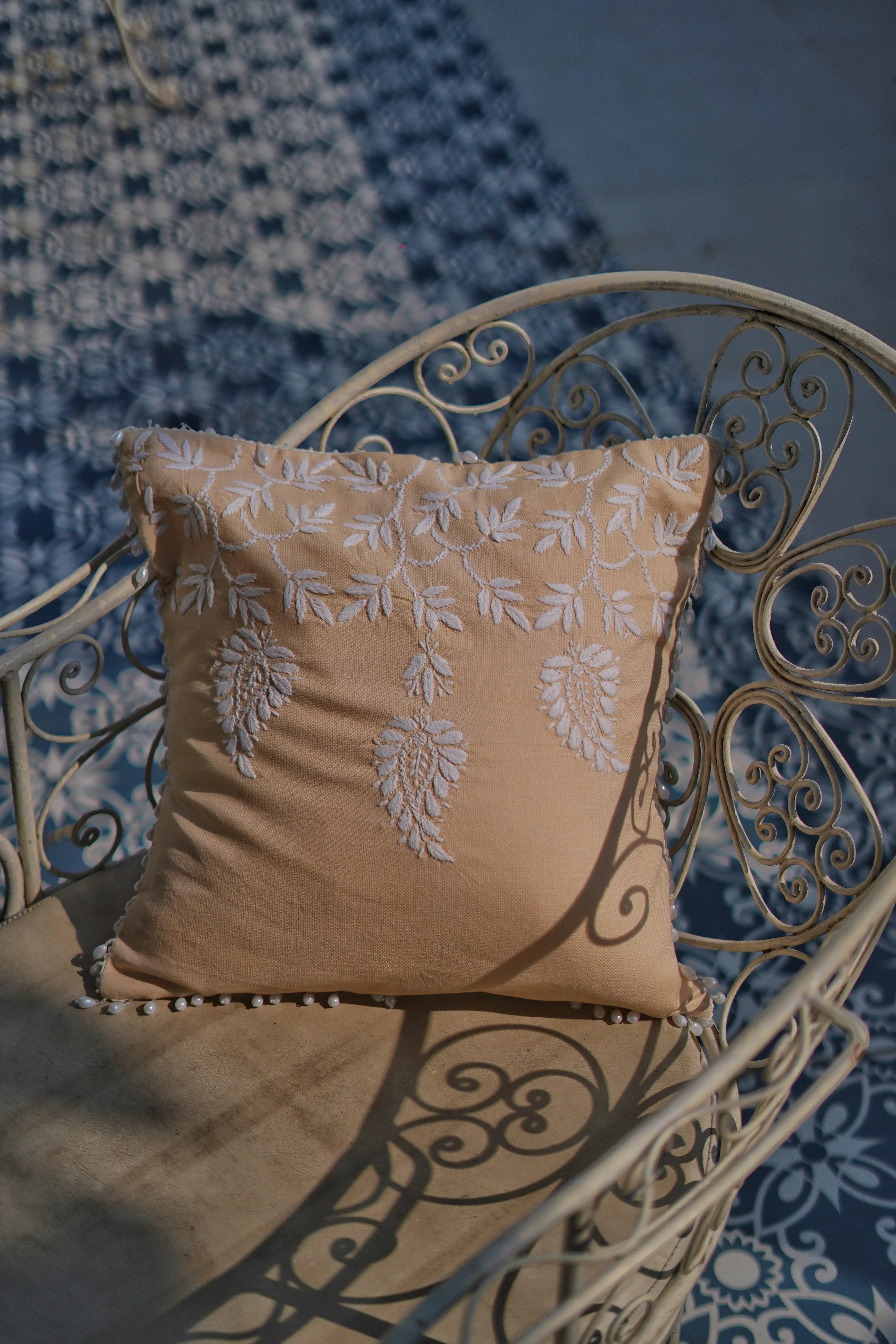 ndian-inspired cushion cover design by Sukhara, blending traditional Chikankari embroidery with mango field aesthetics for unique home decor