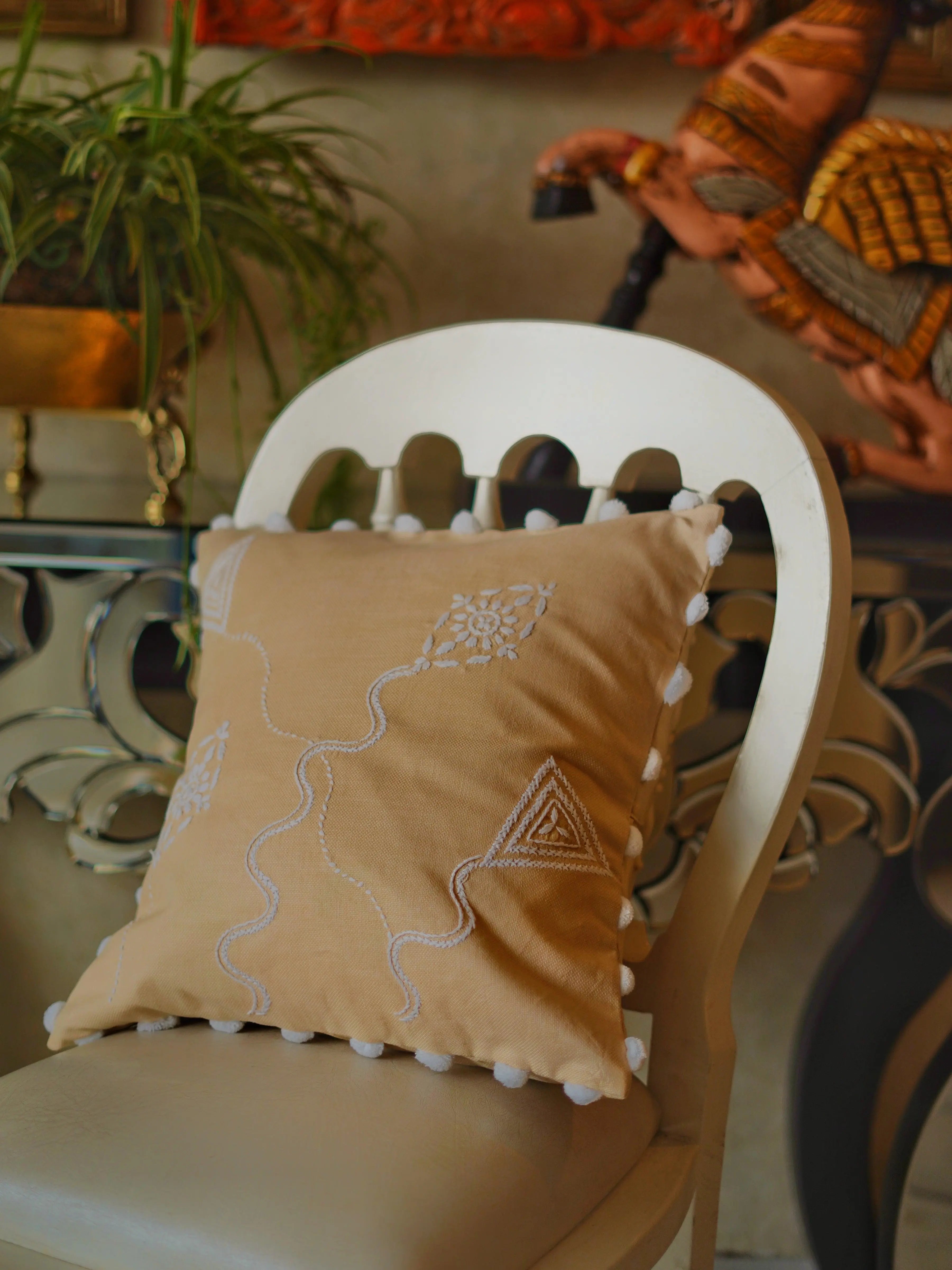 Skilled artisan creating a Lucknow Chikankari cushion cover, showcasing the meticulous craftsmanship of traditional Indian embroidery