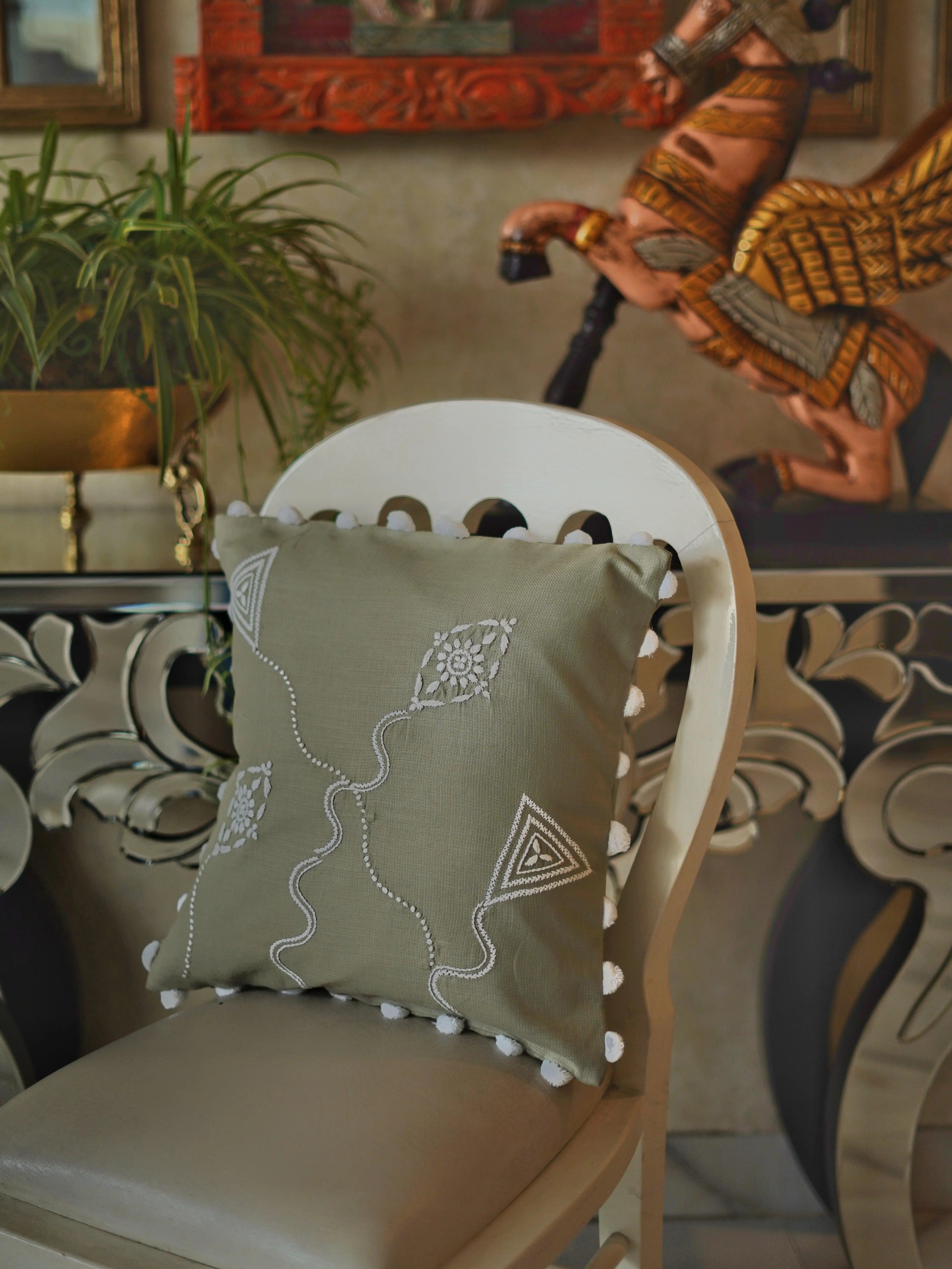 Skilled artisan creating a Lucknow Chikankari cushion cover, showcasing the meticulous craftsmanship of traditional Indian embroidery