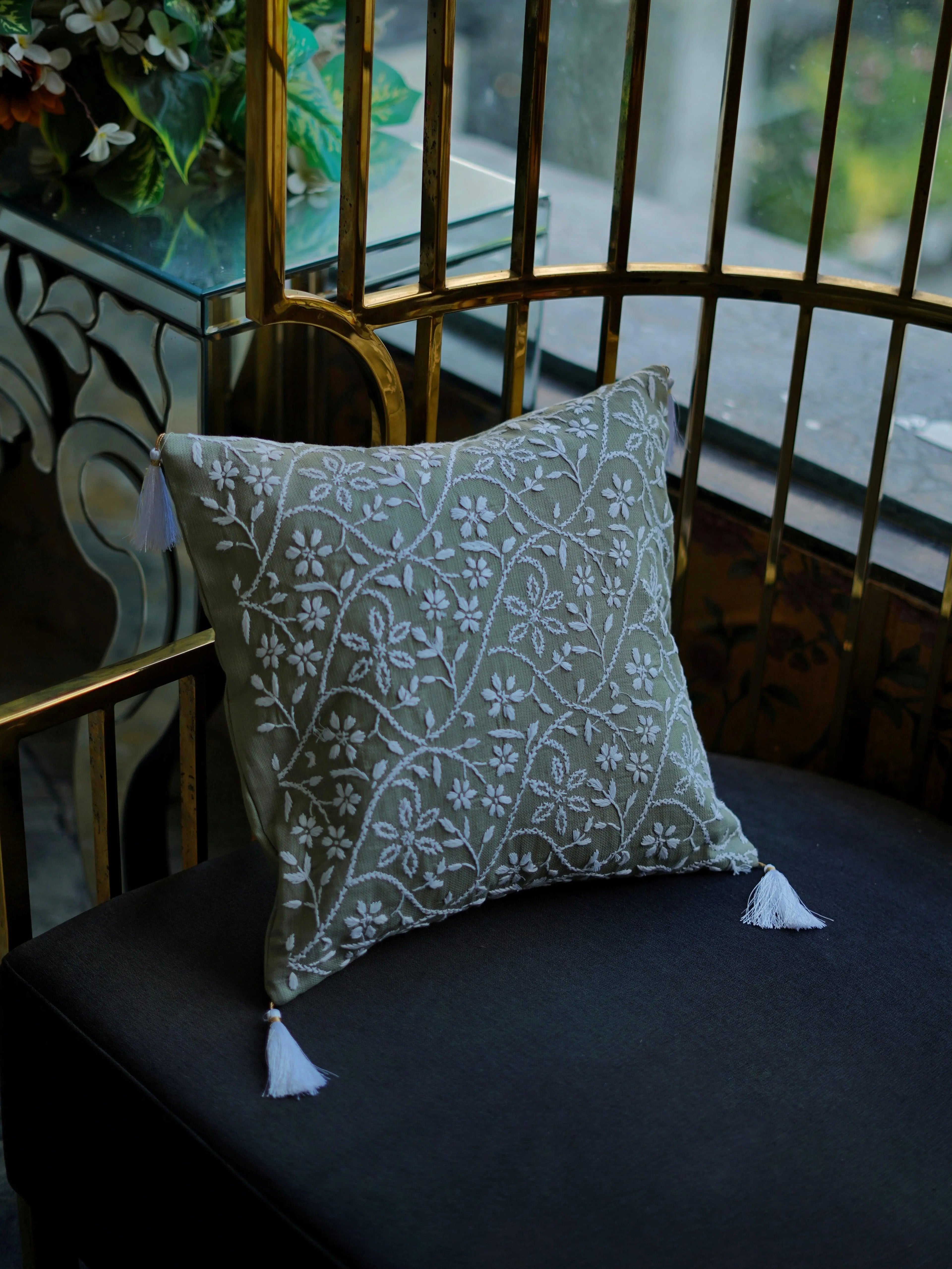 Artistic cushion covers by Sukhara featuring handcrafted Chikankari designs with intricate patte patterns, perfect for luxury living spaces.